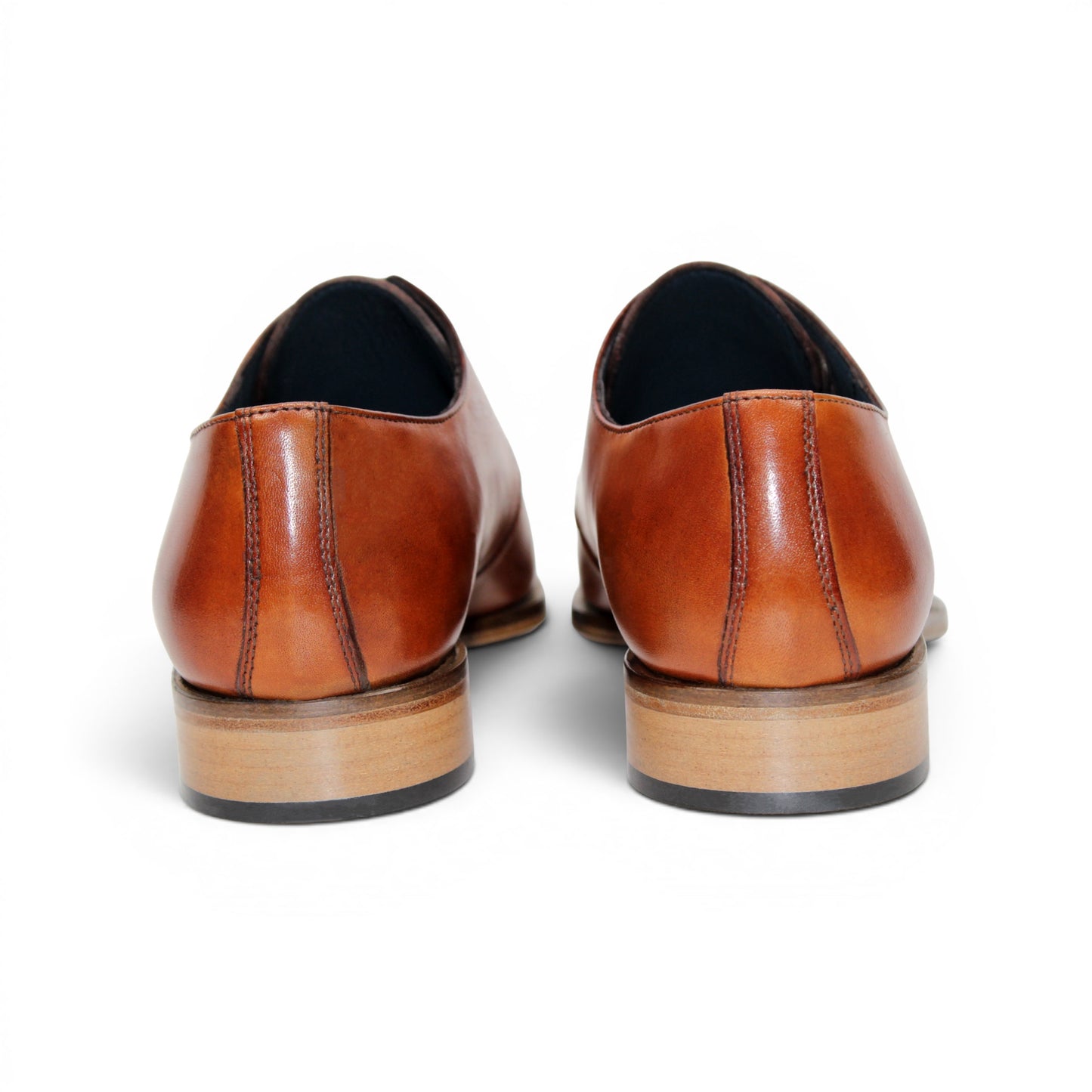 The Duca Sermoneta Cognac by Duca Di Matiste, a classic brown Italian leather dress shoe with a low wooden heel and black lining, is shown in a side view against a white background, highlighting its timeless elegance.