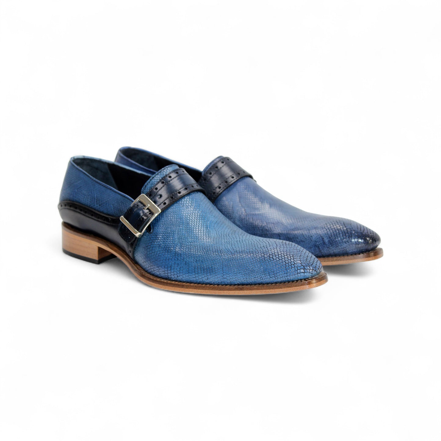 The Duca Di Matiste Duca Sezze Powder Blue/Navy is a luxury leather shoe with blue texture, side buckle, low wooden heel, and pointed toe, crafted in Italy and shown on a white background.