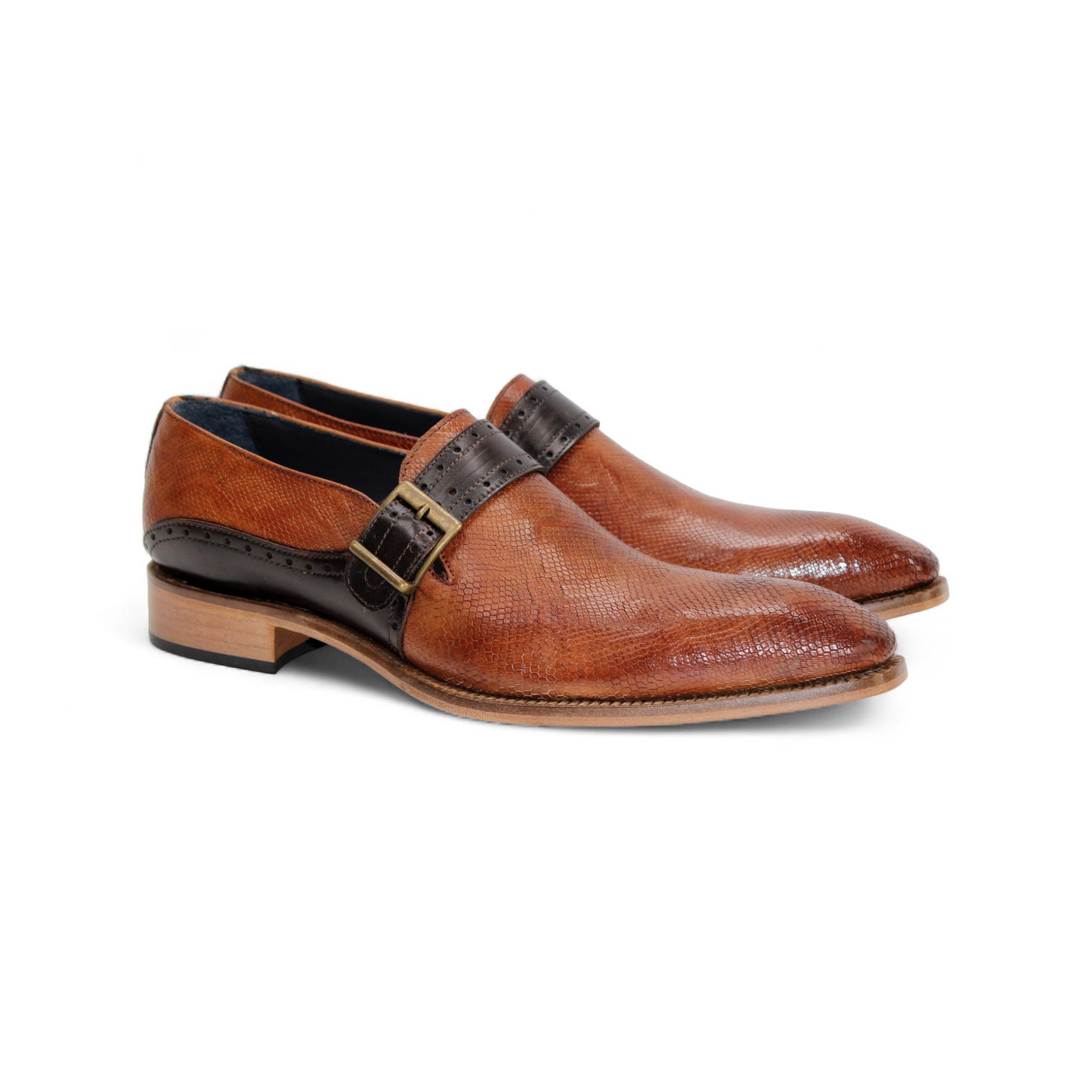 The Duca Sezze Cognac/Chocolate by Duca Di Matiste is a luxurious brown leather dress shoe with a black strap, buckle, and low wooden heel, reflecting Italian craftsmanship in a stylish side profile on a white background.
