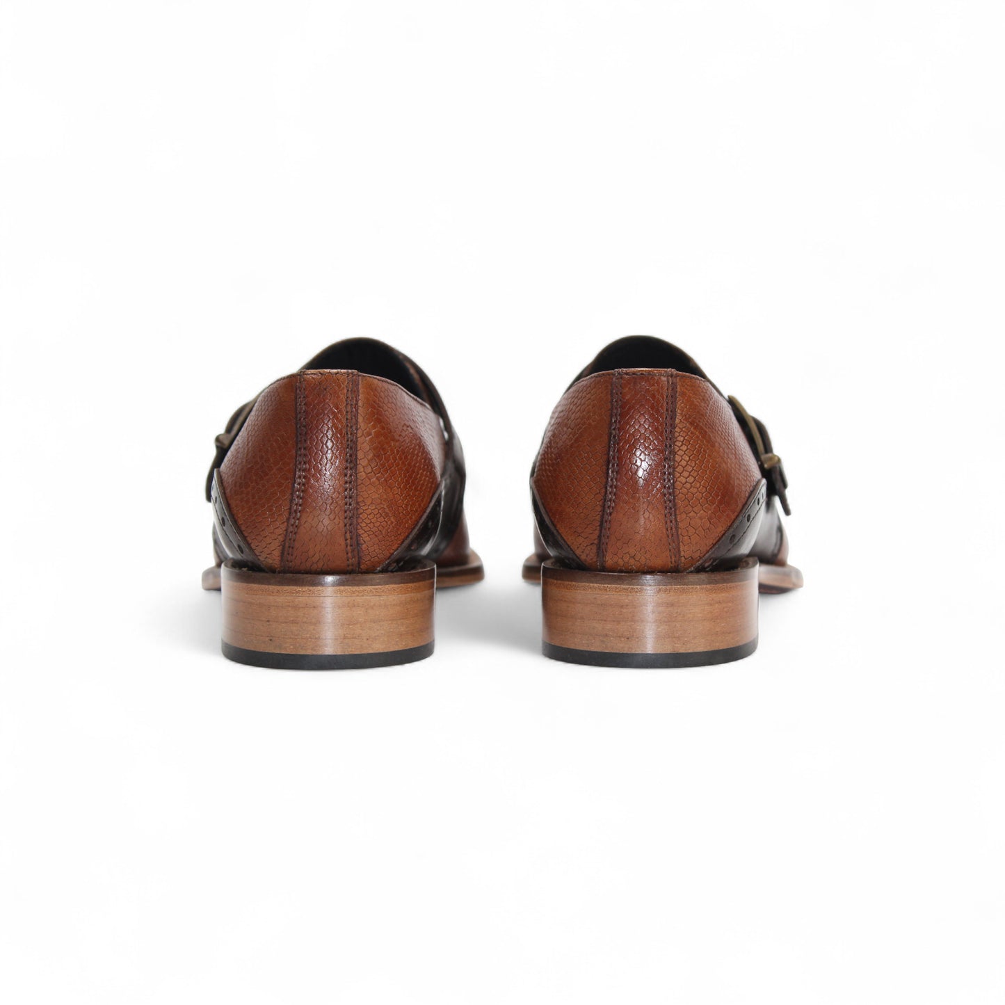 The Duca Sezze Cognac/Chocolate by Duca Di Matiste is a luxurious brown leather dress shoe with a black strap, buckle, and low wooden heel, reflecting Italian craftsmanship in a stylish side profile on a white background.