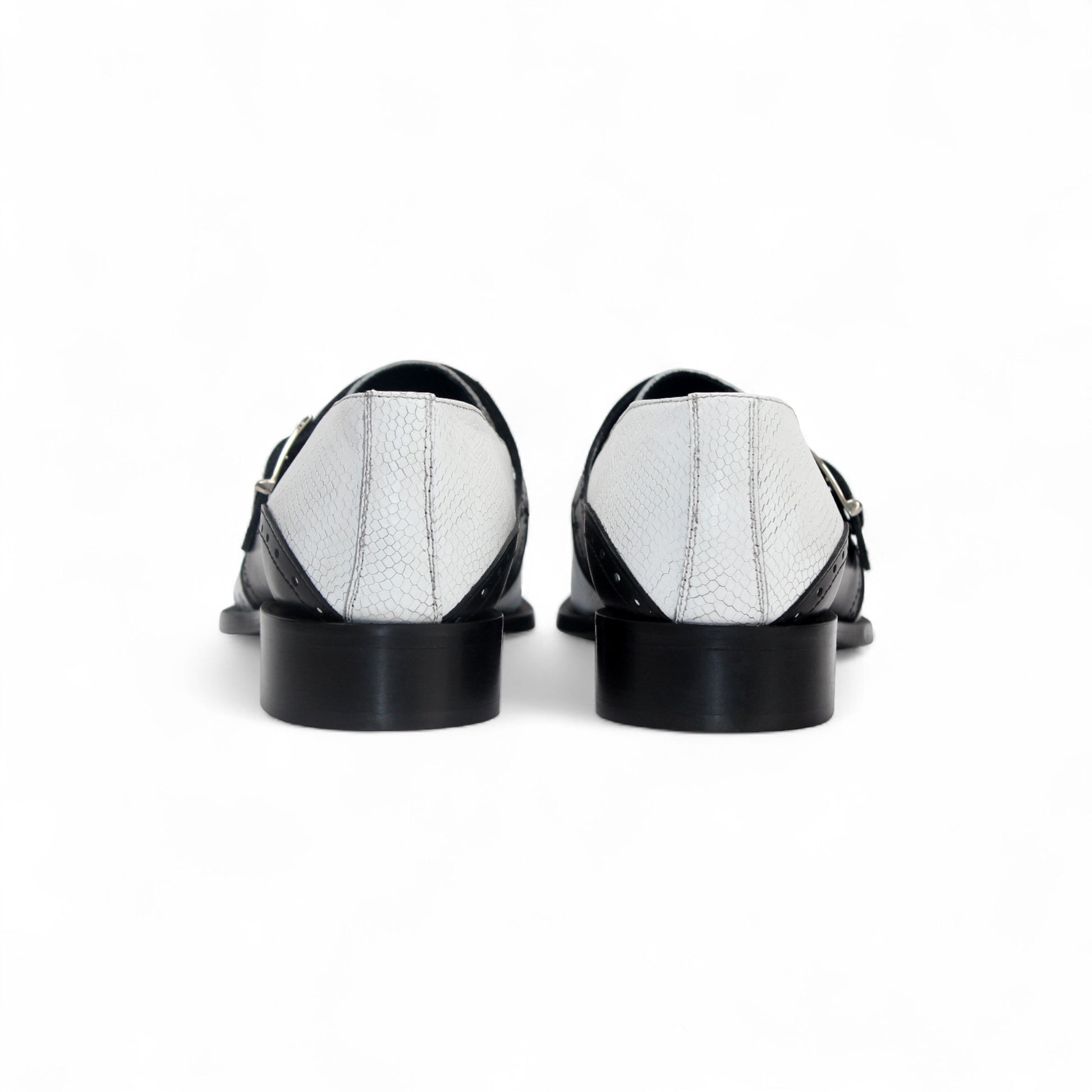 The Duca Di Matiste Duca Sezze White/Black is a white textured dress shoe with a black strap, buckle, low black heel, and pointed toe, highlighting Italian craftsmanship in a side profile on a white background.