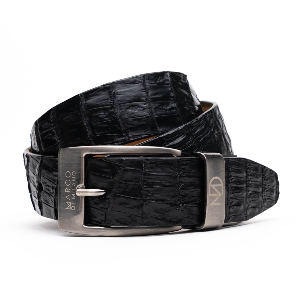 Silvio Belt Black by Marco Di Milano—crafted from black crocodile-embossed leather in the refined style of caiman fuscus-back belts, this belt features meticulous hand-painted finishes and a silver buckle engraved with the Marco Di Milano logo, elegantly coiled on a white background.