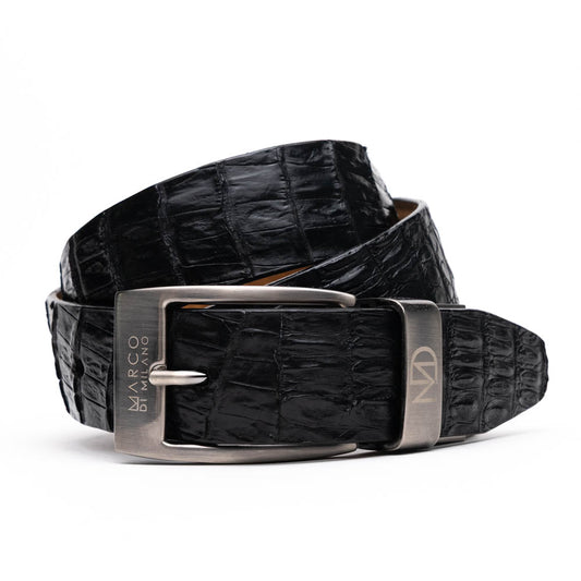 Silvio Belt Black by Marco Di Milano—crafted from black crocodile-embossed leather in the refined style of caiman fuscus-back belts, this belt features meticulous hand-painted finishes and a silver buckle engraved with the Marco Di Milano logo, elegantly coiled on a white background.
