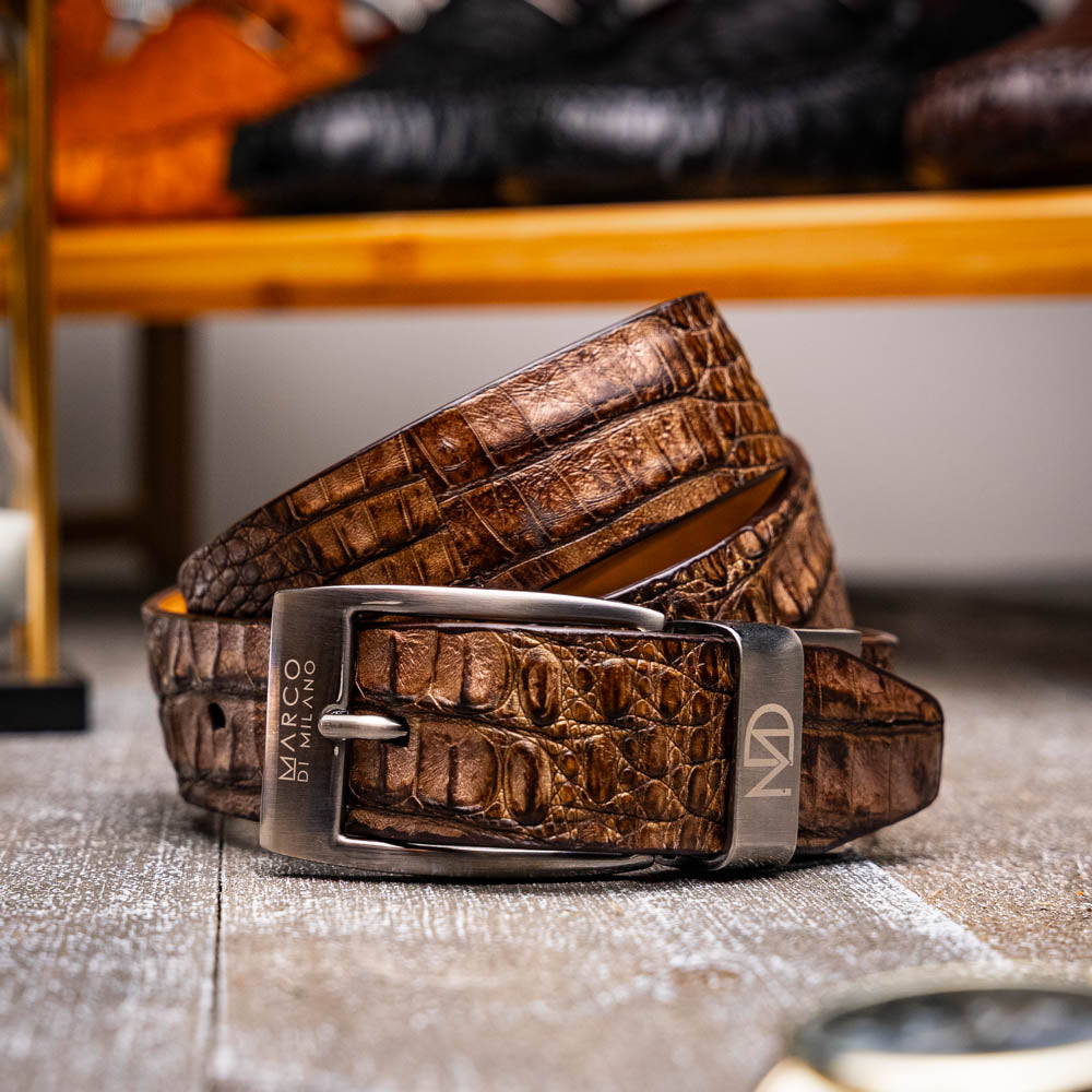 The Silvio Belt Washed Brown by Marco Di Milano is crafted from genuine crocodile-pattern leather and features a metal buckle engraved with the brand’s logo.