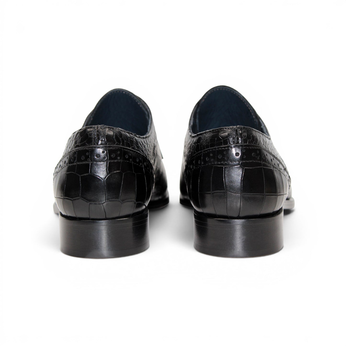 The Duca Di Matiste Duca Spada Black is a black Italian leather dress shoe with an embossed crocodile pattern, low heel, and lace-up design, shown in side profile on a white background. Expertly crafted in Italy for elegant style.