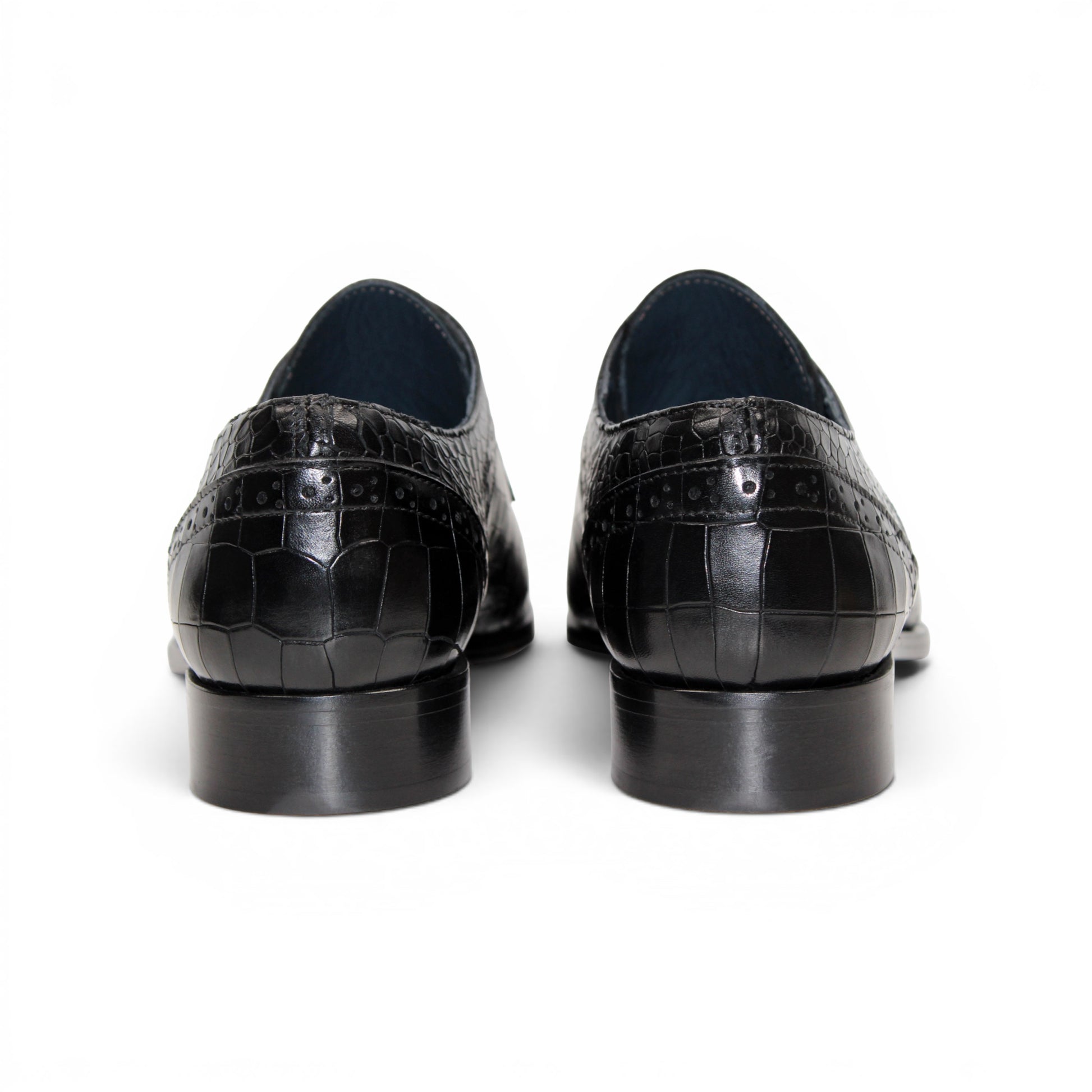 The Duca Di Matiste Duca Spada Black is a black Italian leather dress shoe with an embossed crocodile pattern, low heel, and lace-up design, shown in side profile on a white background. Expertly crafted in Italy for elegant style.
