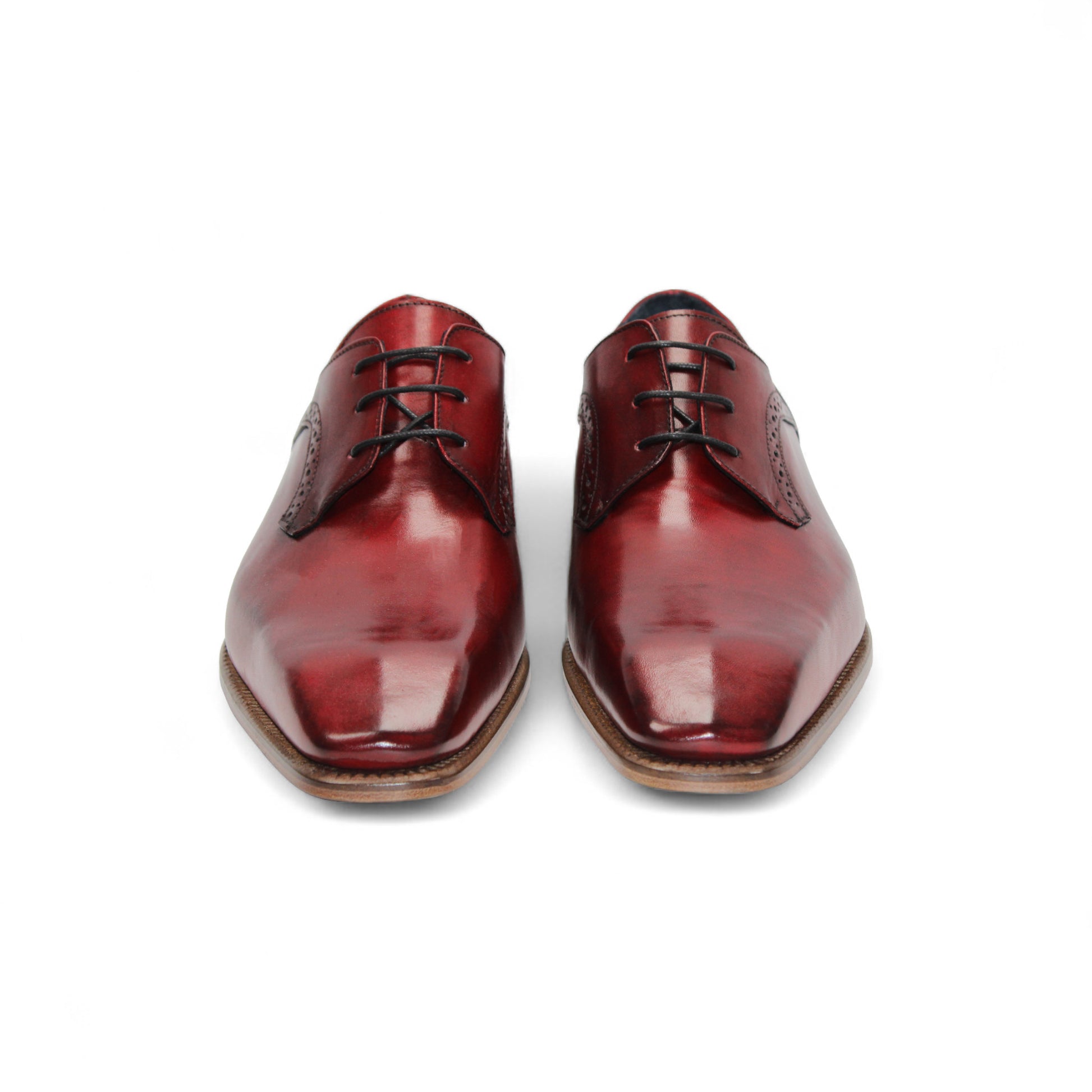 The Duca Di Matiste Duca Spada Antique Red is an Italian leather dress shoe in red with brogue detailing, black laces, and a light brown wooden sole, shown in profile on a white background.