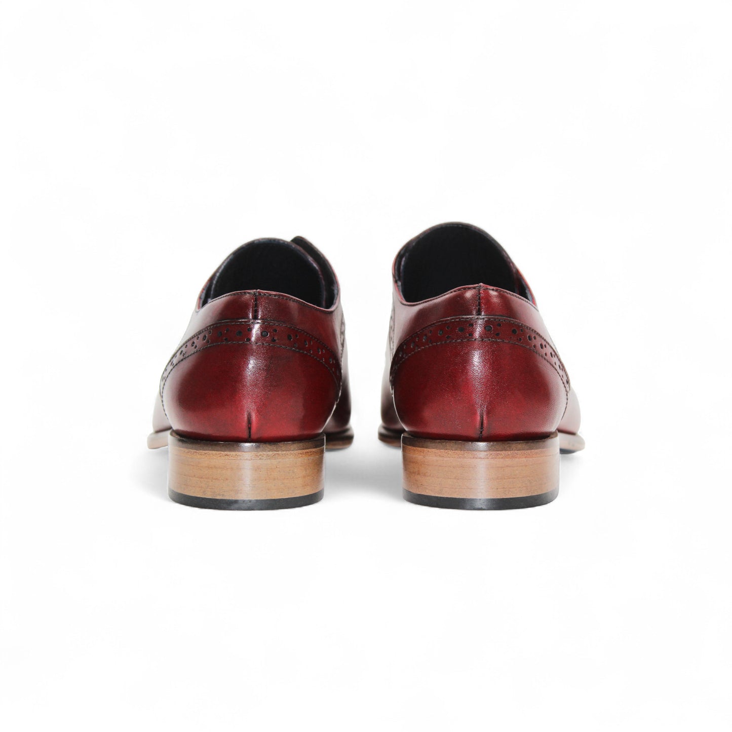 The Duca Di Matiste Duca Spada Antique Red is an Italian leather dress shoe in red with brogue detailing, black laces, and a light brown wooden sole, shown in profile on a white background.
