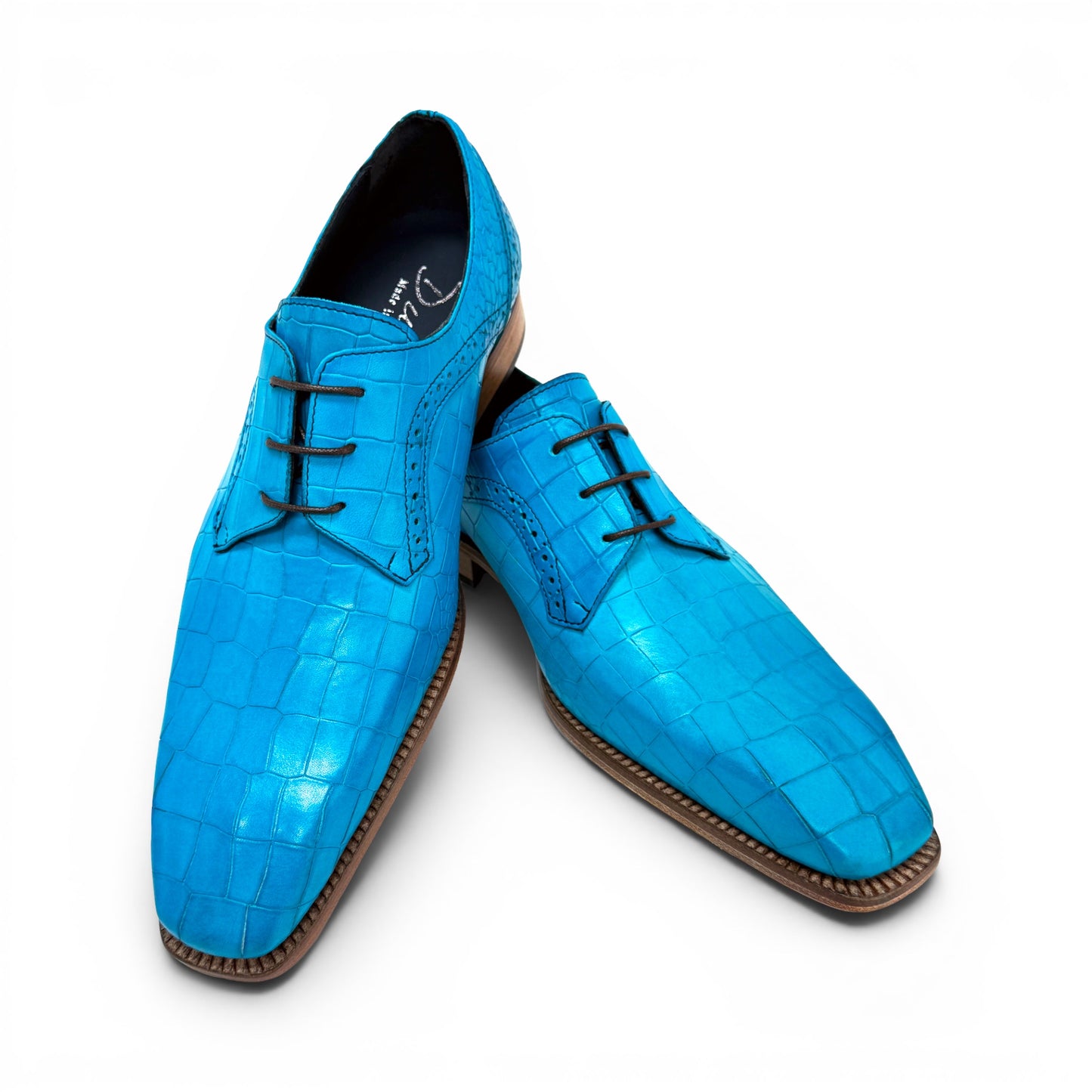 The Duca Di Matiste Duca Spada Turquoise is an Italian-made turquoise leather shoe with a crocodile pattern, black laces, and a light brown sole, shown in side profile against a white background.