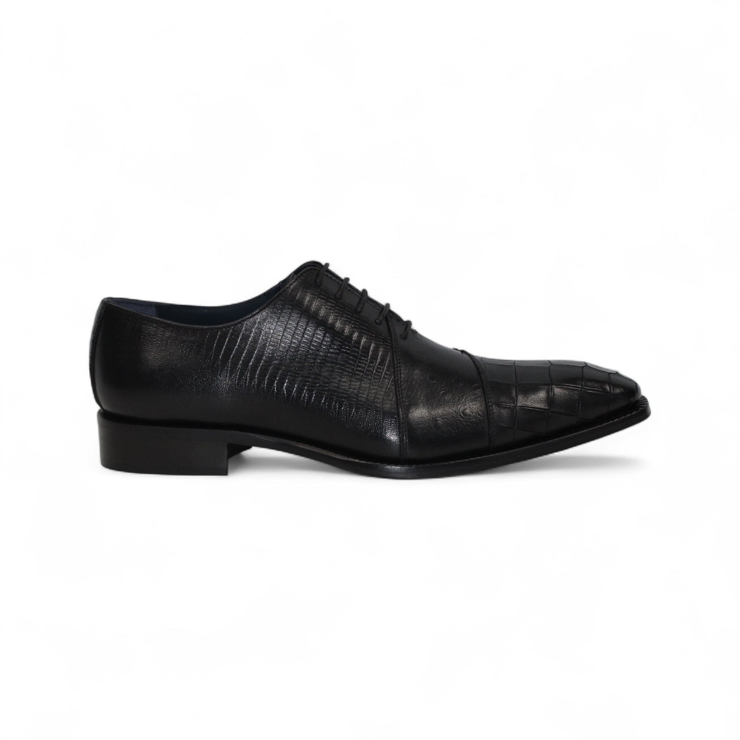 The Duca Spoleto I Black by Duca Di Matiste is a black luxury leather shoe with a pointed toe and embossed pattern, shown in a side view against a white background.