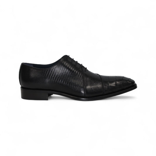 The Duca Spoleto I Black by Duca Di Matiste is a black luxury leather shoe with a pointed toe and embossed pattern, shown in a side view against a white background.