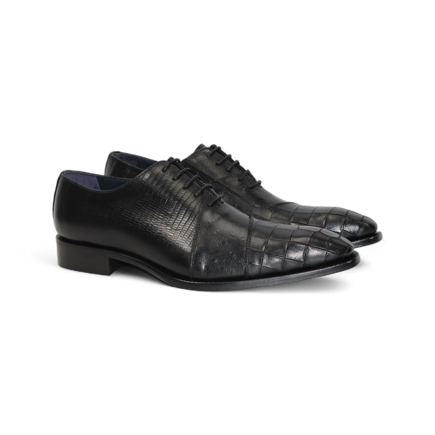 The Duca Spoleto I Black by Duca Di Matiste is a black luxury leather shoe with a pointed toe and embossed pattern, shown in a side view against a white background.