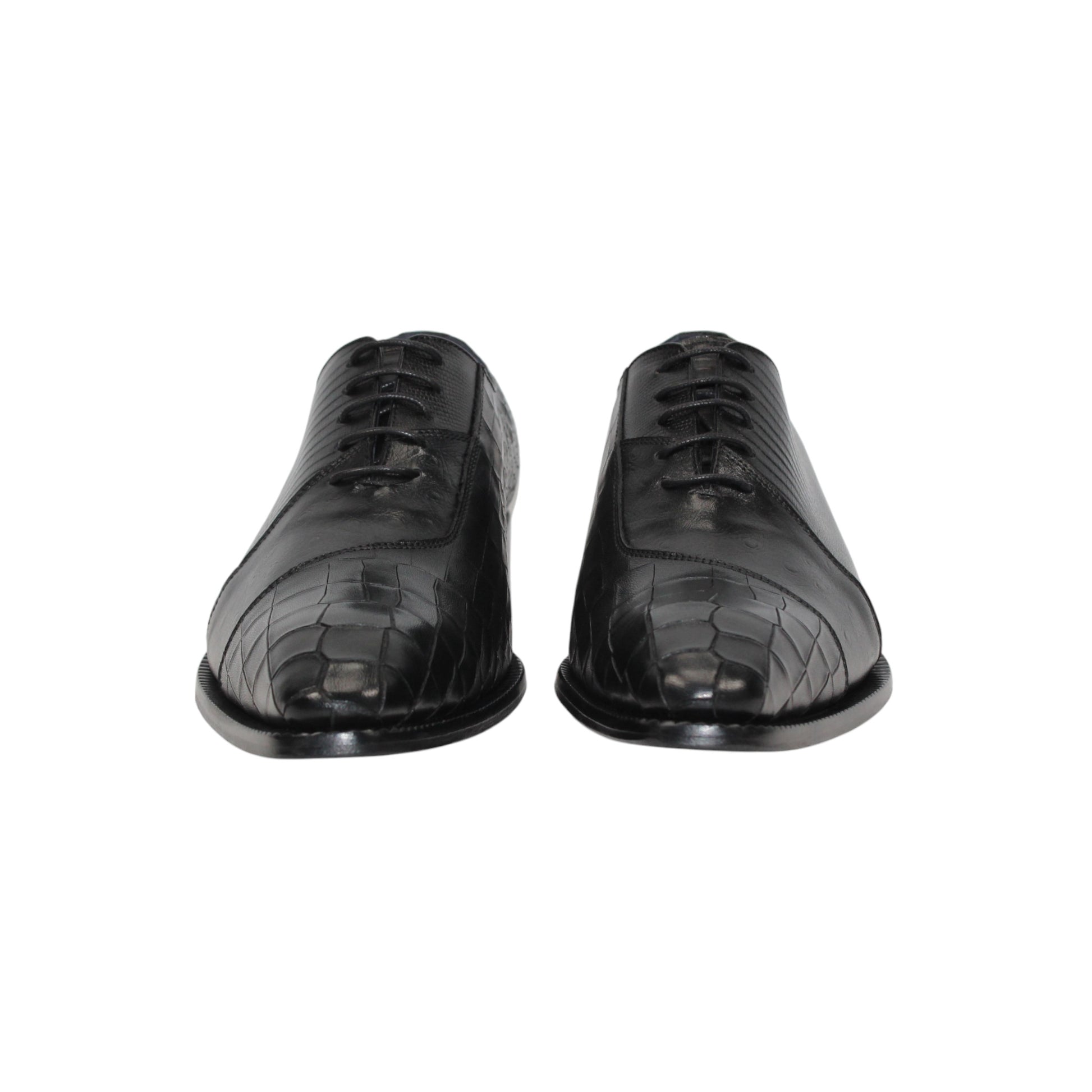 The Duca Spoleto I Black by Duca Di Matiste is a black luxury leather shoe with a pointed toe and embossed pattern, shown in a side view against a white background.