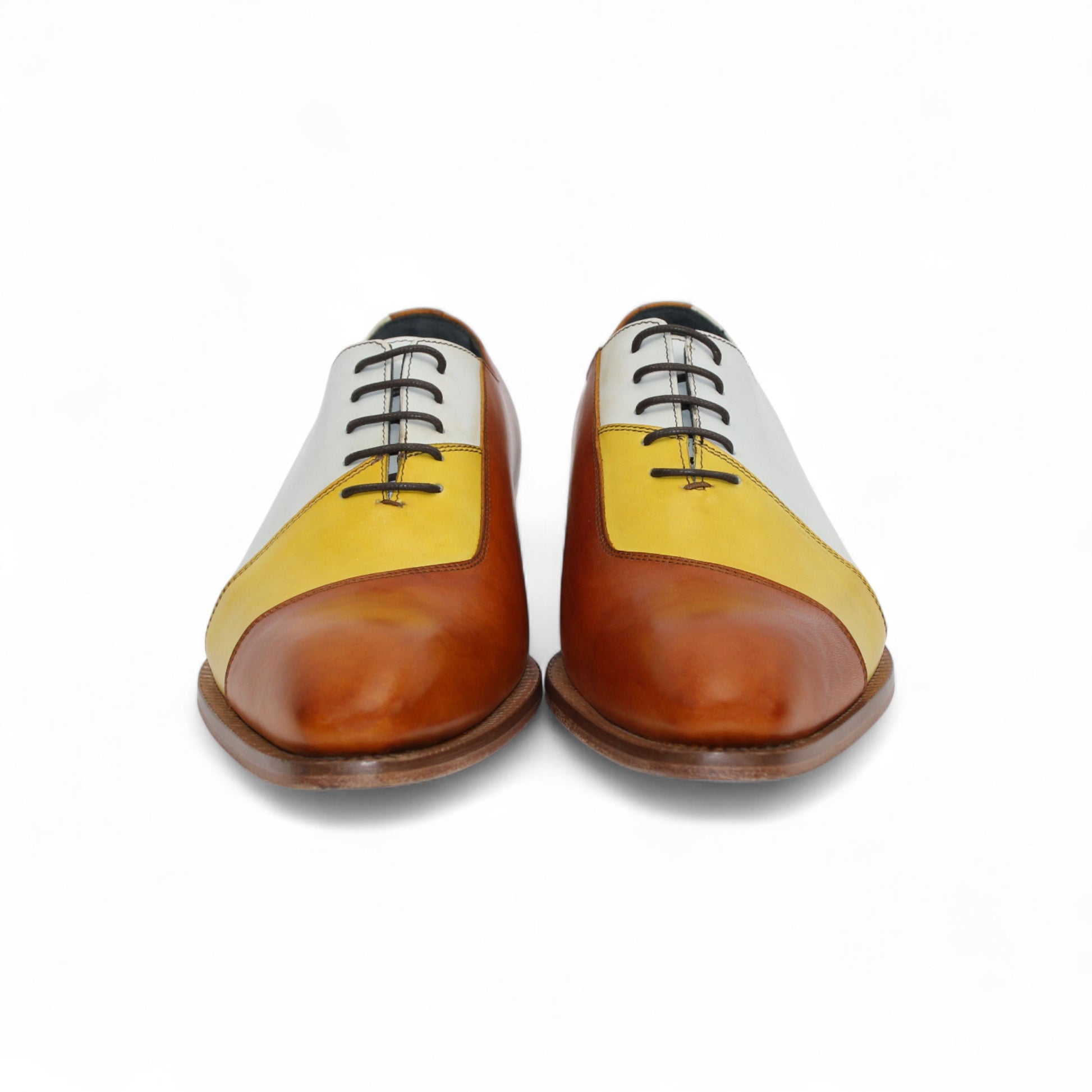 The Duca Spoleto II Yellow Combo by Duca Di Matiste is a luxury leather dress shoe in white, yellow, and brown color blocks with black laces and a light brown sole, expertly handcrafted in Italy and shown in side view on a white background.