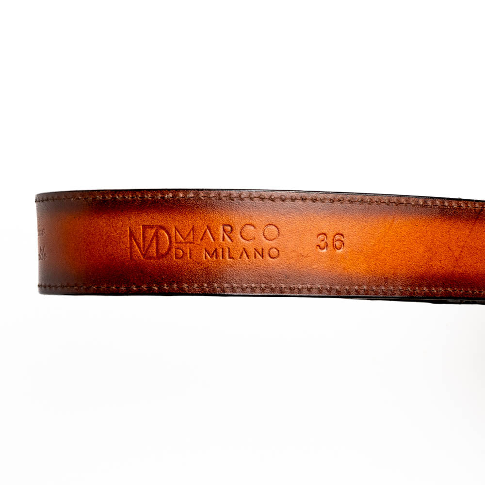The Texas Belt Aged Maple by Marco Di Milano is crafted from luxurious caiman crocodile skin in a brown finish, featuring a large brass buckle engraved with "MD" and the brand name embossed on the leather.