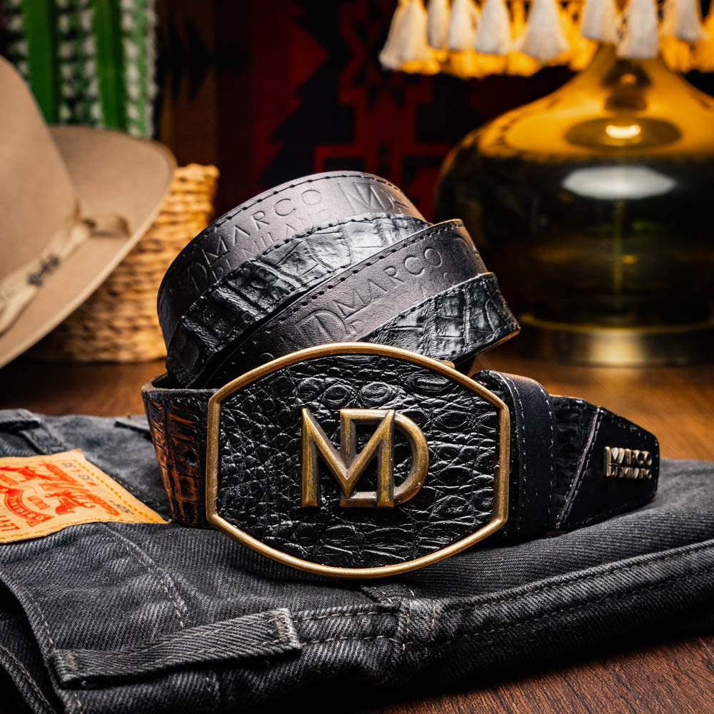 The Texas Belt Black by Marco Di Milano features a bold gold "MD" buckle and embossed branding, styled like a Western belt for a striking statement.