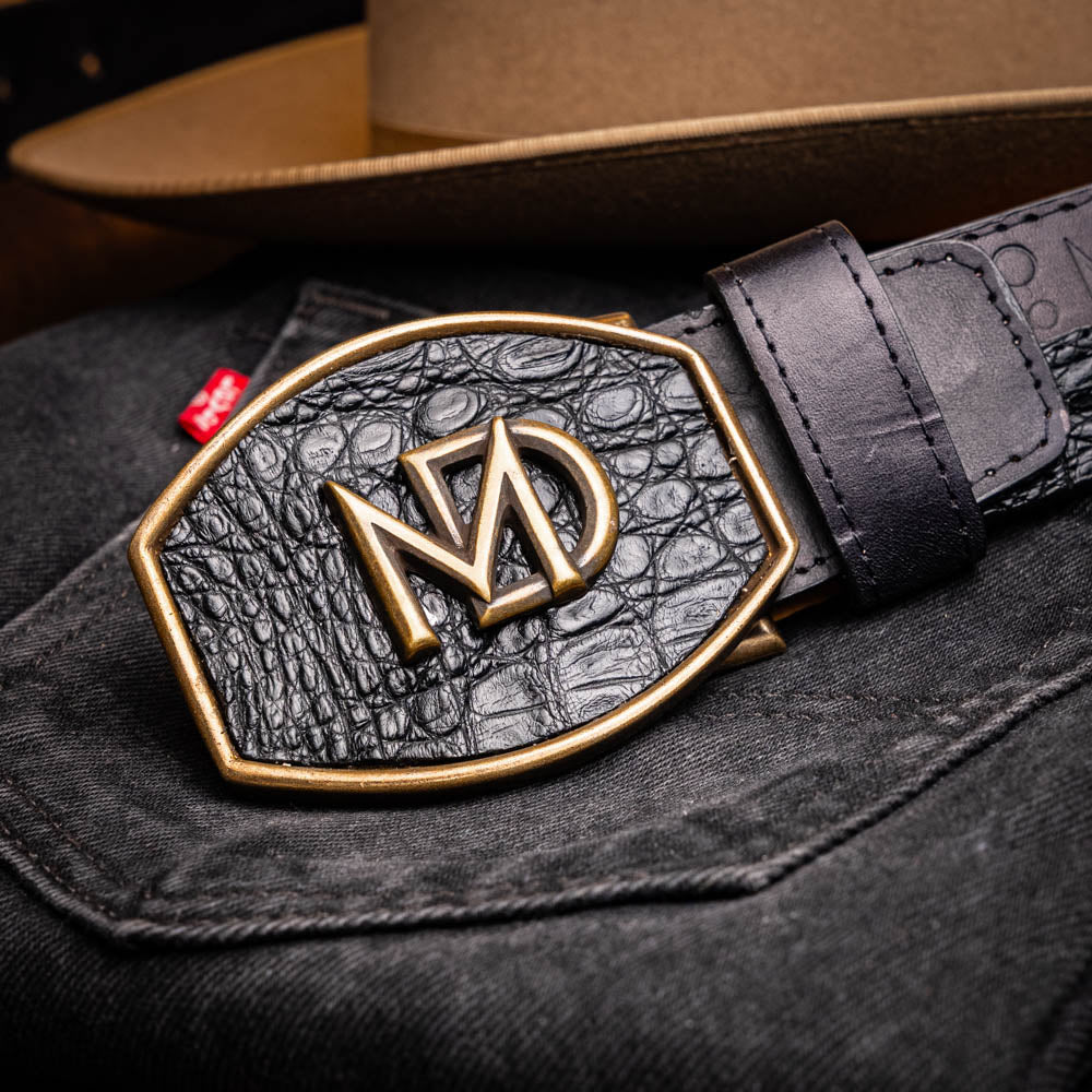 The Texas Belt Black by Marco Di Milano features a bold gold "MD" buckle and embossed branding, styled like a Western belt for a striking statement.