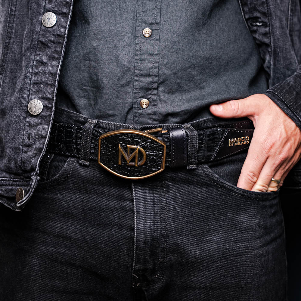 The Texas Belt Black by Marco Di Milano features a bold gold "MD" buckle and embossed branding, styled like a Western belt for a striking statement.