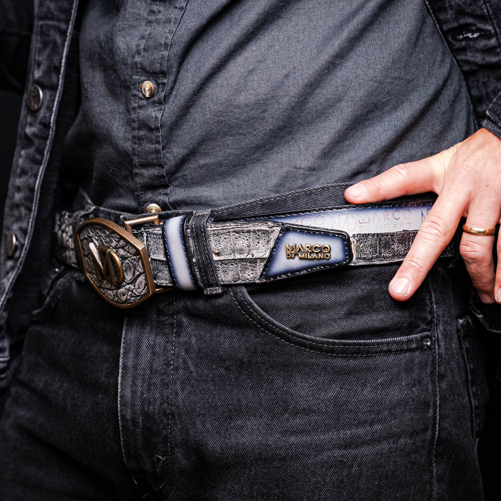 The Marco Di Milano Texas Belt Stone Gray features a textured gray finish, a large gold MD logo buckle, and "Marco Di Milano" printed along the strap.