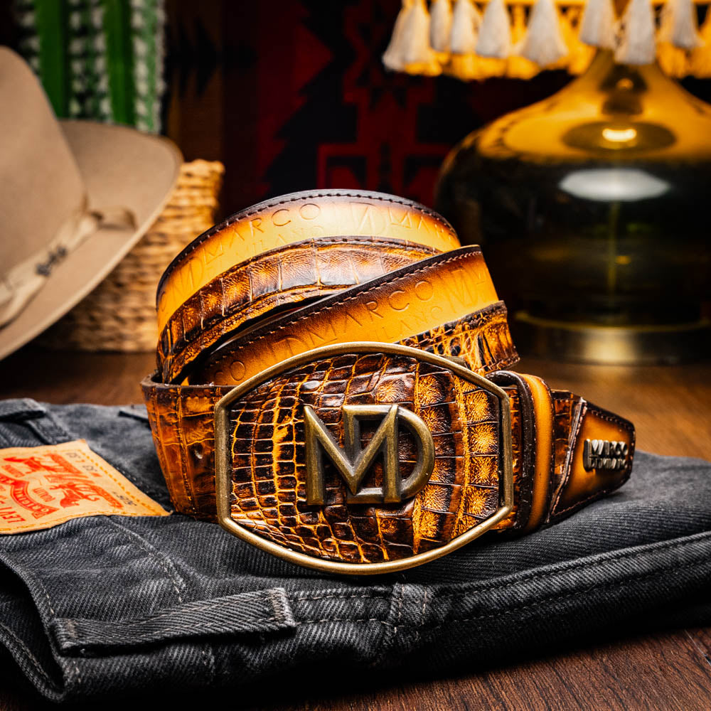 The Texas Belt Mustard Brown by Marco Di Milano features a striking gold "MD" logo buckle—an elegant statement accessory embodying modern sophistication.