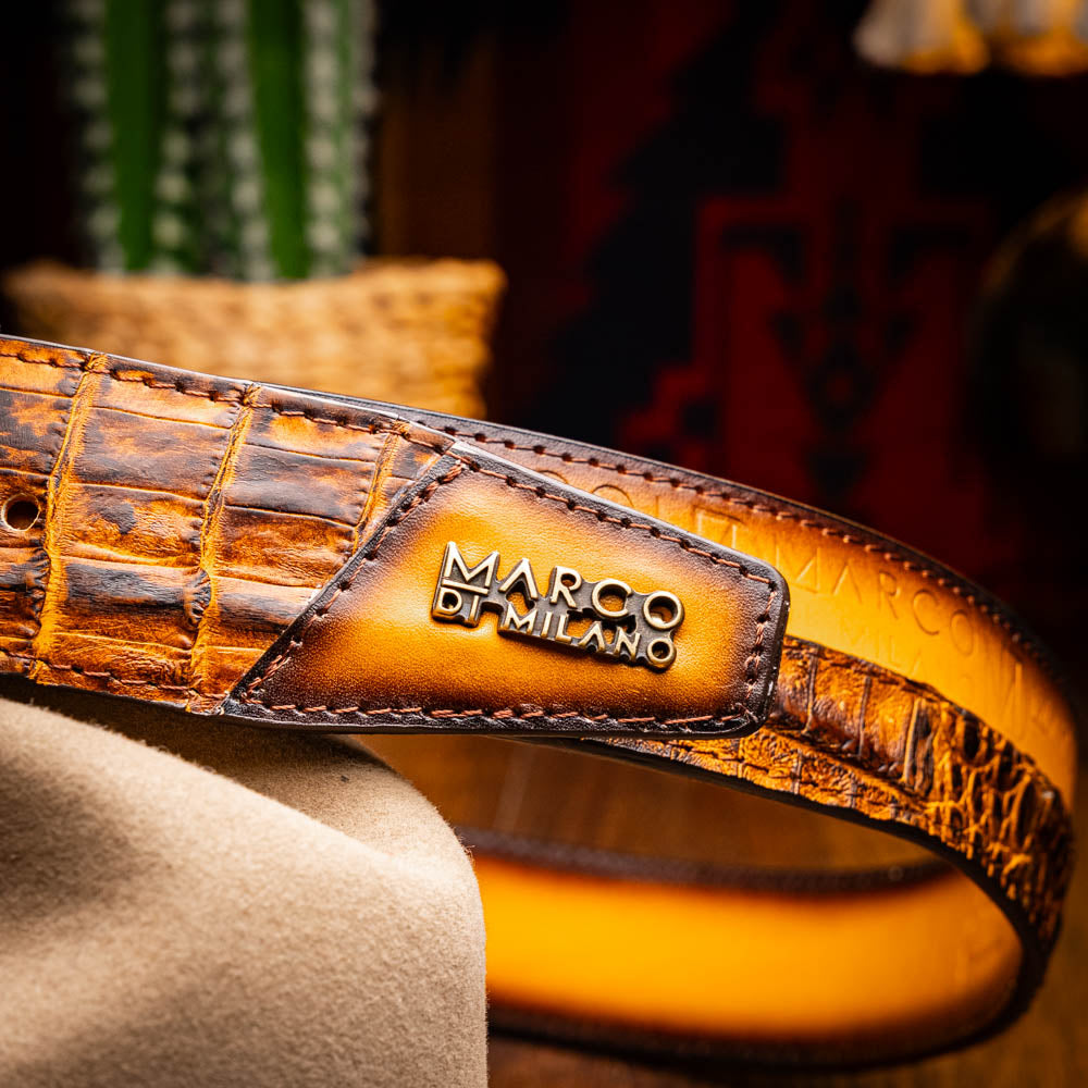 The Texas Belt Mustard Brown by Marco Di Milano features a striking gold "MD" logo buckle—an elegant statement accessory embodying modern sophistication.