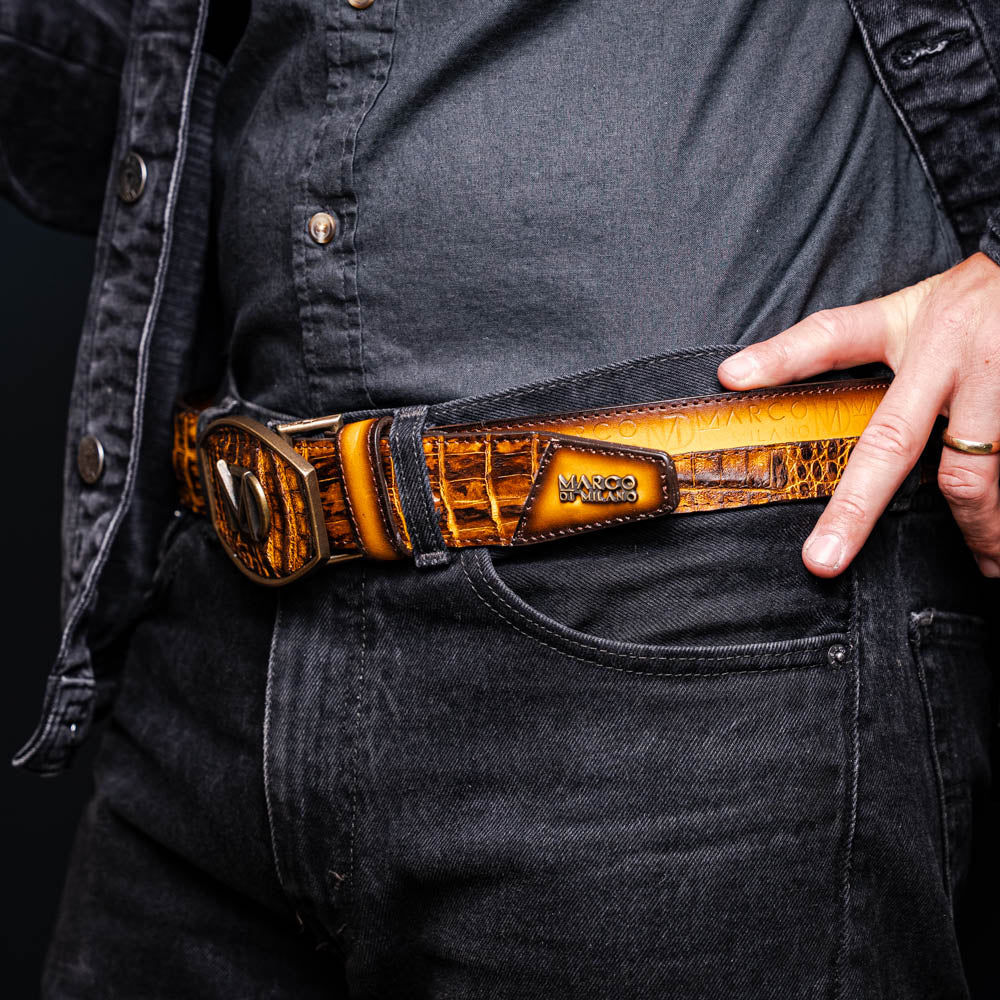 The Texas Belt Mustard Brown by Marco Di Milano features a striking gold "MD" logo buckle—an elegant statement accessory embodying modern sophistication.