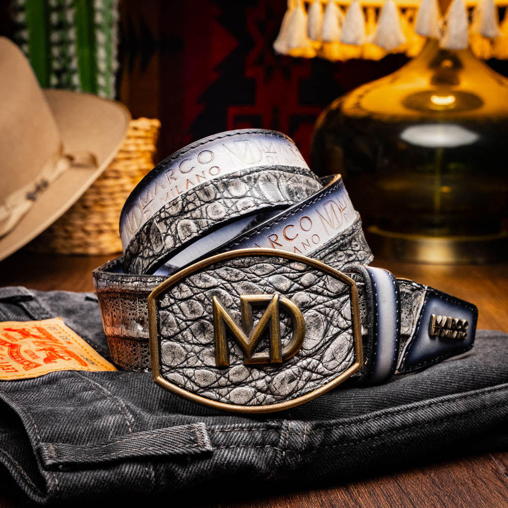 The Marco Di Milano Texas Belt Stone Gray features a textured gray finish, a large gold MD logo buckle, and "Marco Di Milano" printed along the strap.