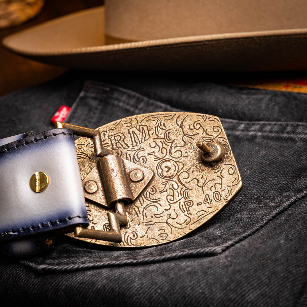 The Marco Di Milano Texas Belt Stone Gray features a textured gray finish, a large gold MD logo buckle, and "Marco Di Milano" printed along the strap.