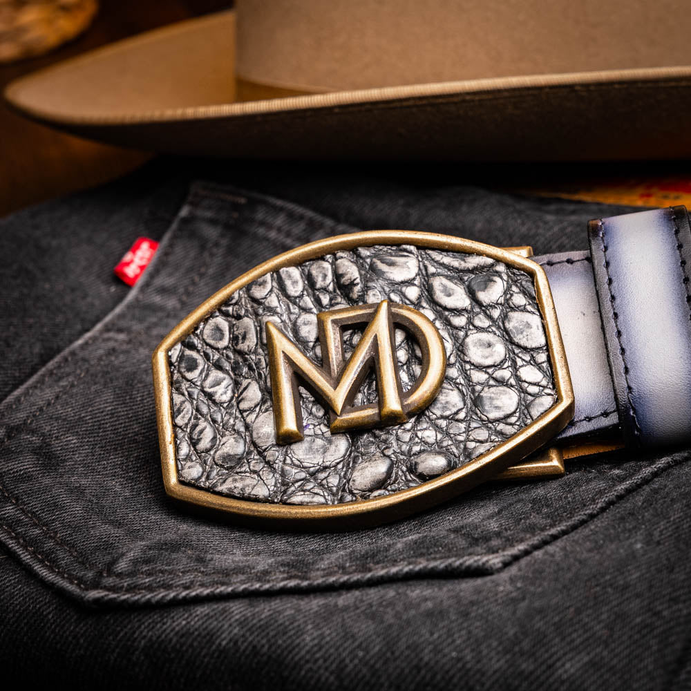 The Marco Di Milano Texas Belt Stone Gray features a textured gray finish, a large gold MD logo buckle, and "Marco Di Milano" printed along the strap.