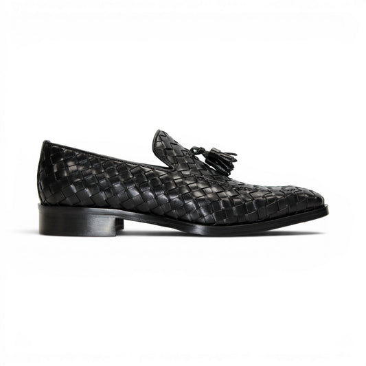 The Duca Di Matiste Duca Tirrenea Black is a black calf weave leather loafer with tassel detail, low heel, and rounded toe, shown in side profile on a white background—an elegant piece of luxury footwear.