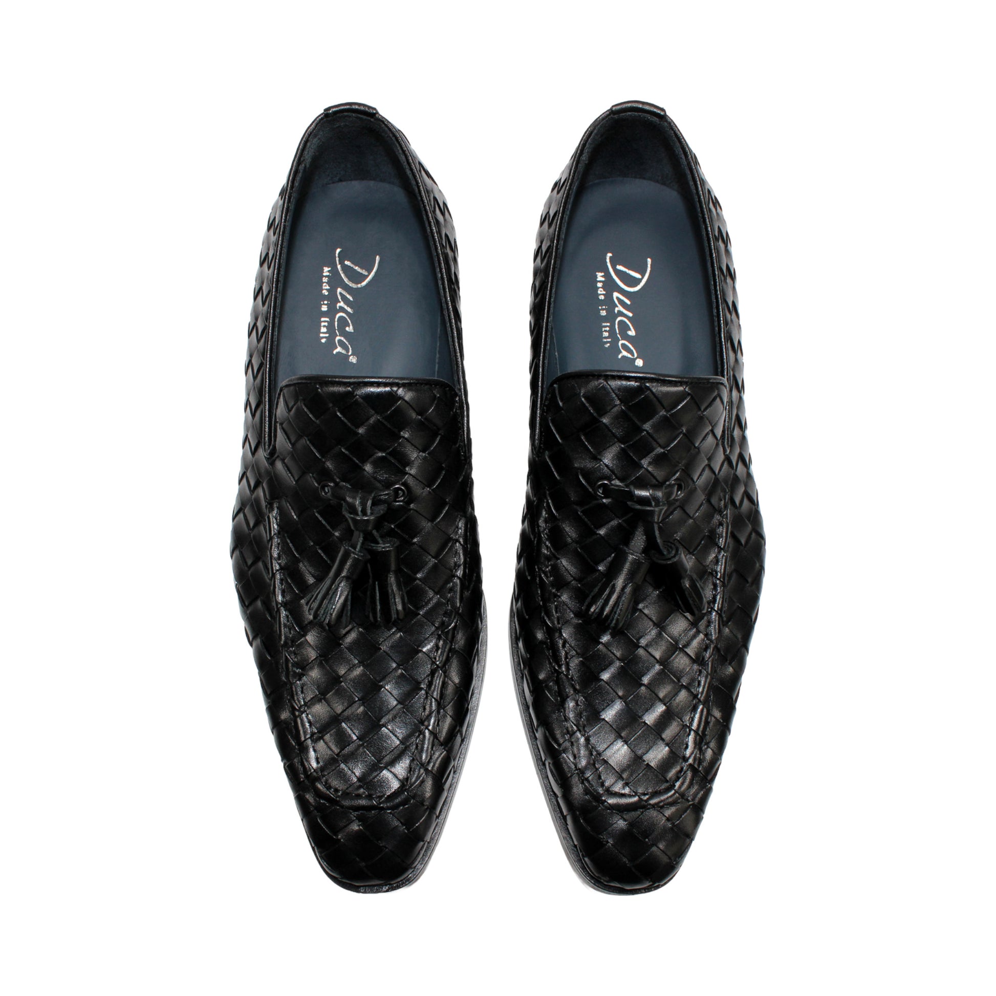 The Duca Di Matiste Duca Tirrenea Black is a black calf weave leather loafer with tassel detail, low heel, and rounded toe, shown in side profile on a white background—an elegant piece of luxury footwear.