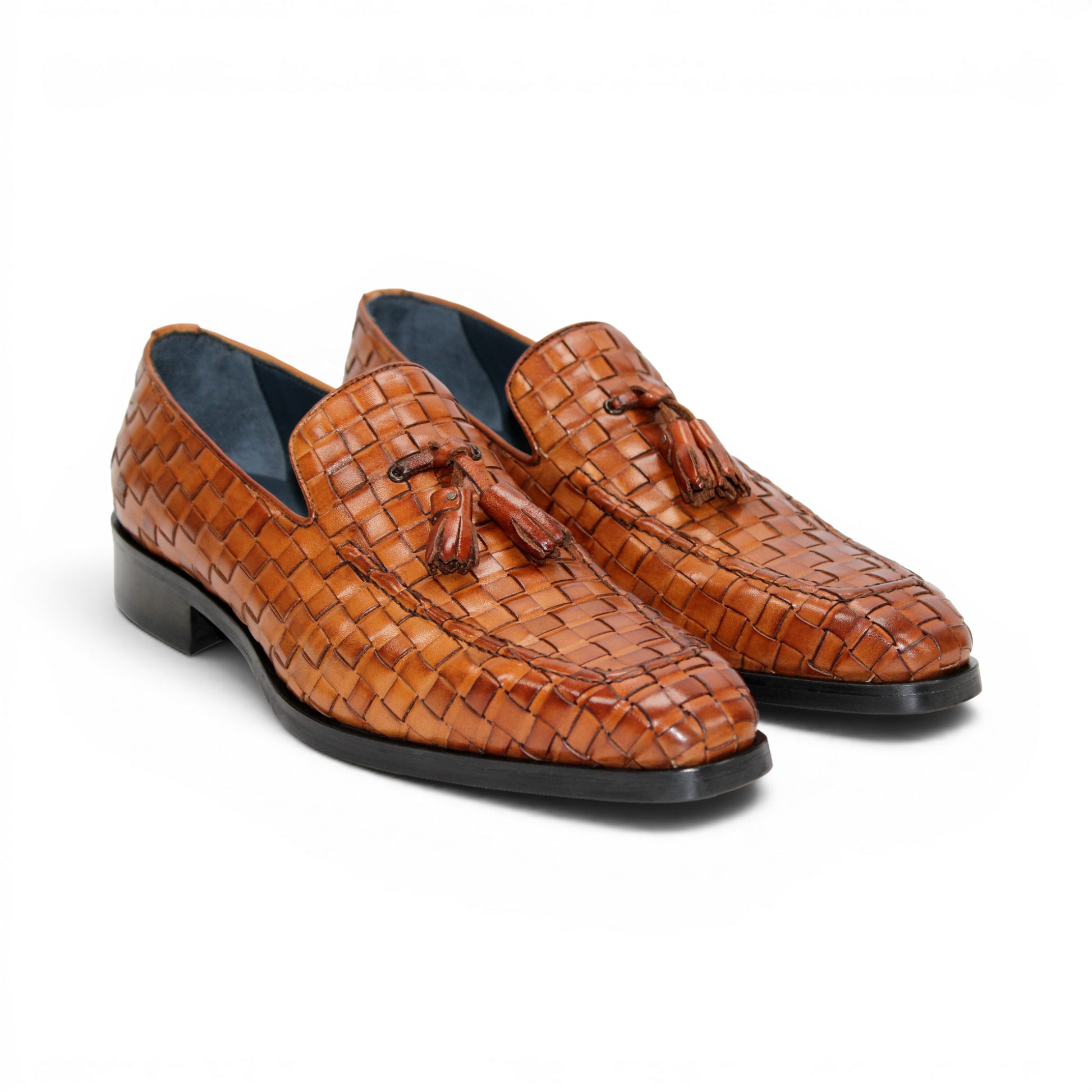 Duca Di Matiste's Duca Tirrenea Cognac: a brown Italian calf weave leather loafer with tassels, low heel, and black sole—luxury footwear shown in side profile on a white background.