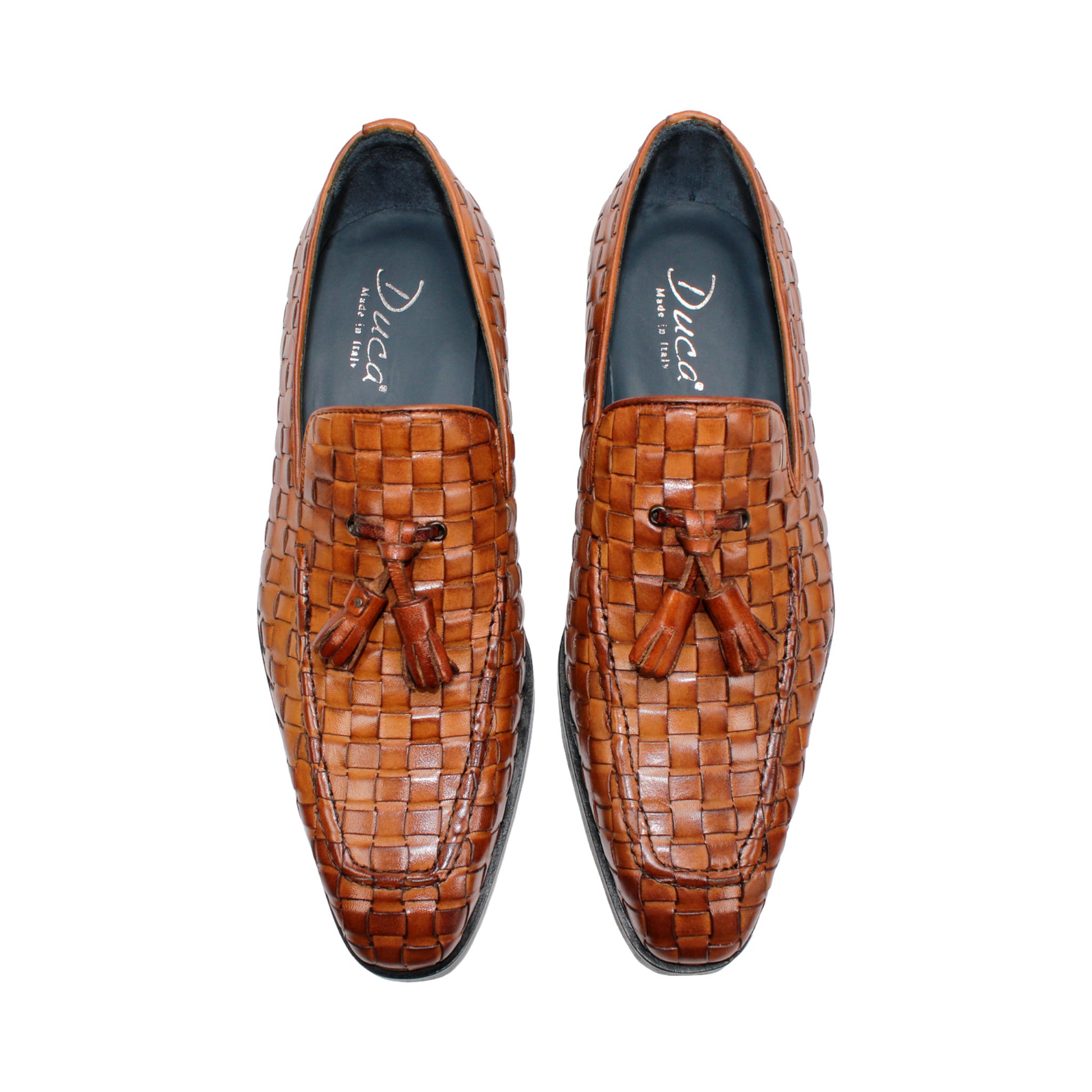 Duca Di Matiste's Duca Tirrenea Cognac: a brown Italian calf weave leather loafer with tassels, low heel, and black sole—luxury footwear shown in side profile on a white background.