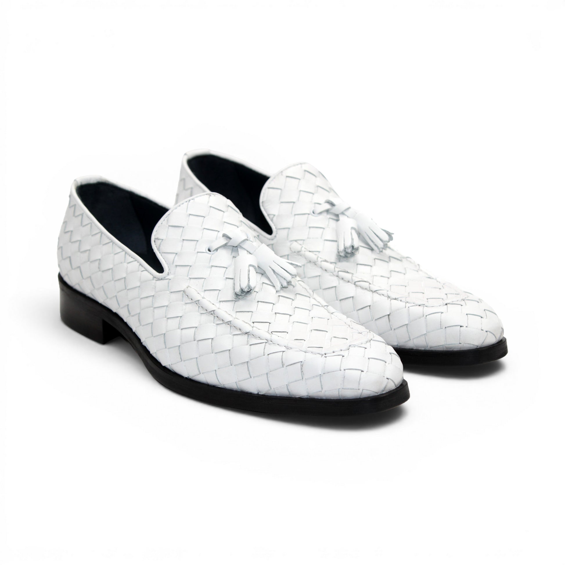 The Duca Tirrenea White by Duca Di Matiste is a white calf weave leather loafer with tassel detail and a black low heel, elegantly crafted in Italy and shown in profile against a plain white background.
