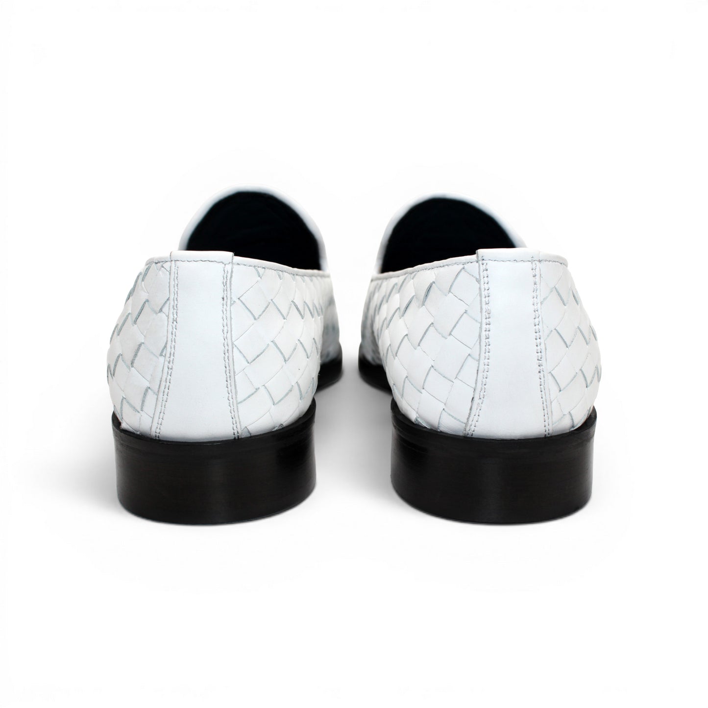 The Duca Tirrenea White by Duca Di Matiste is a white calf weave leather loafer with tassel detail and a black low heel, elegantly crafted in Italy and shown in profile against a plain white background.