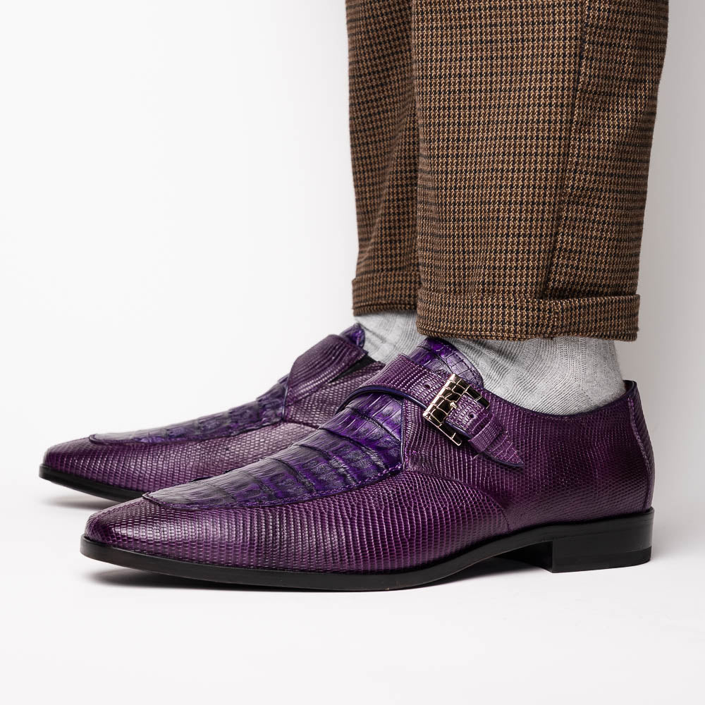 The Toluca Purple by Marco Di Milano is a pair of luxury monk strap shoes with textured purple leather, a silver buckle, red inner lining, and vibrant purple soles—one shoe rests against the other to showcase its unique sole design.