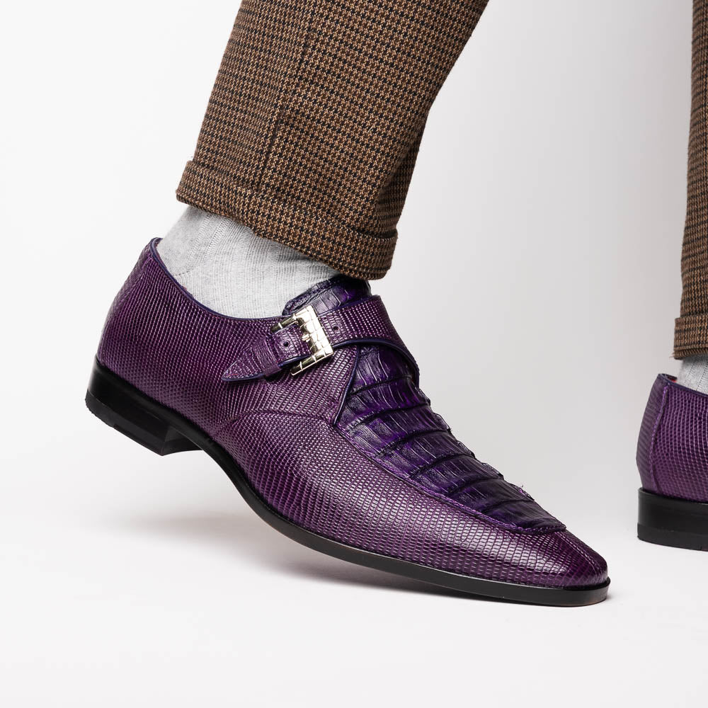 The Toluca Purple by Marco Di Milano is a pair of luxury monk strap shoes with textured purple leather, a silver buckle, red inner lining, and vibrant purple soles—one shoe rests against the other to showcase its unique sole design.