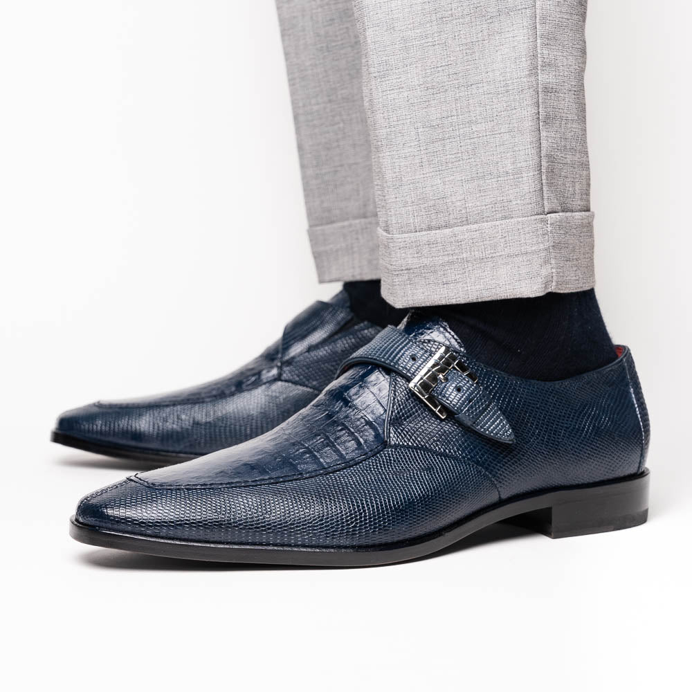 Toluca Navy by Marco Di Milano: a pair of blue textured leather monk strap shoes with a single buckle—one upright, one sole-up showing the brand name—a luxury footwear choice for refined tastes.