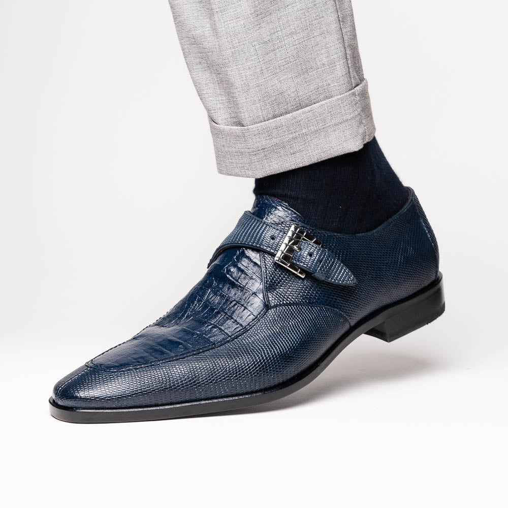Toluca Navy by Marco Di Milano: a pair of blue textured leather monk strap shoes with a single buckle—one upright, one sole-up showing the brand name—a luxury footwear choice for refined tastes.