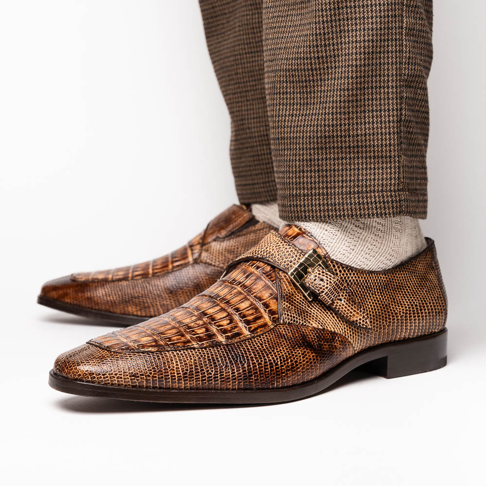 A pair of Toluca Rustic Orix brown leather monk strap shoes by Marco Di Milano, featuring a crocodile pattern—one upright and one showing the branded sole—luxurious footwear perfect for any occasion.