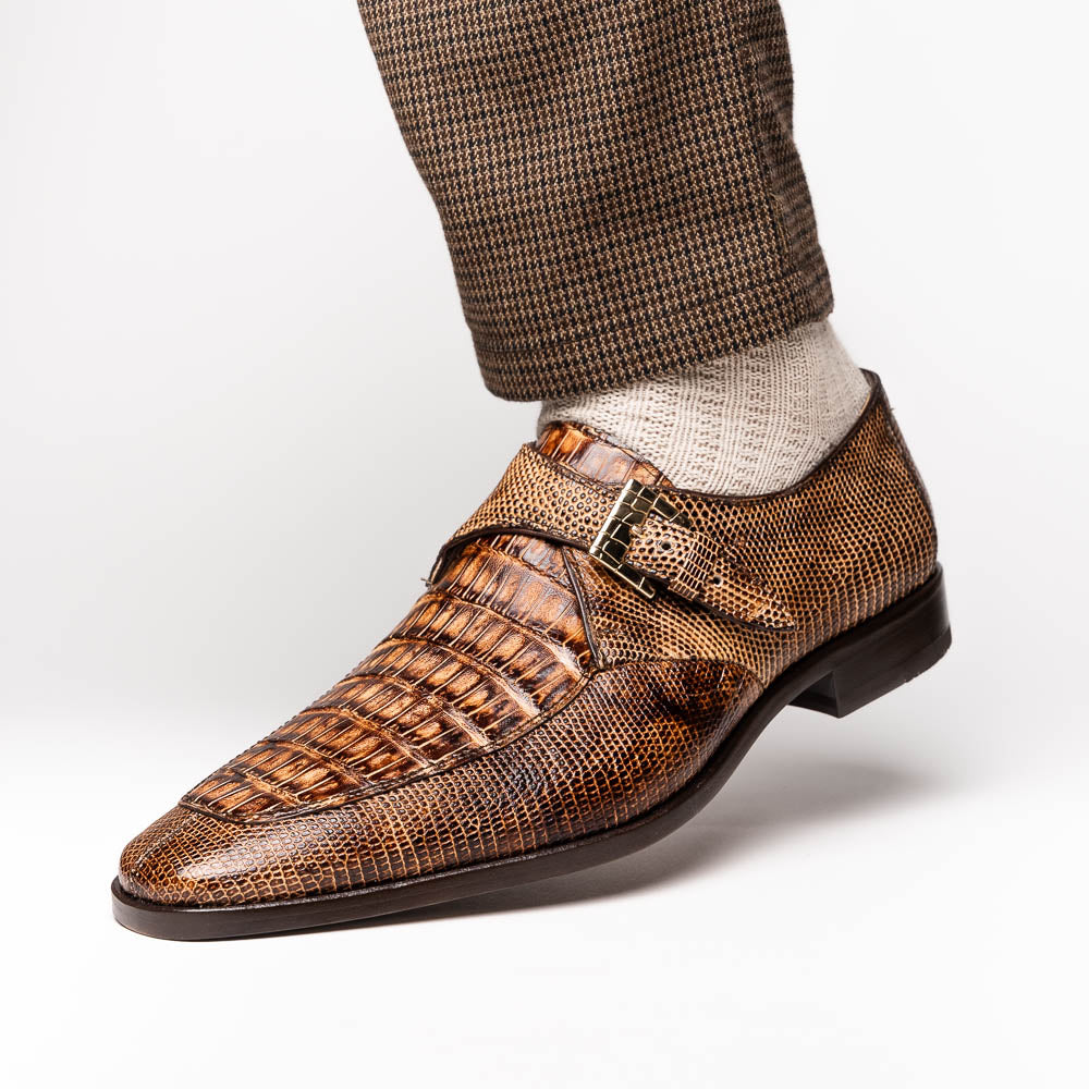 A pair of Toluca Rustic Orix brown leather monk strap shoes by Marco Di Milano, featuring a crocodile pattern—one upright and one showing the branded sole—luxurious footwear perfect for any occasion.