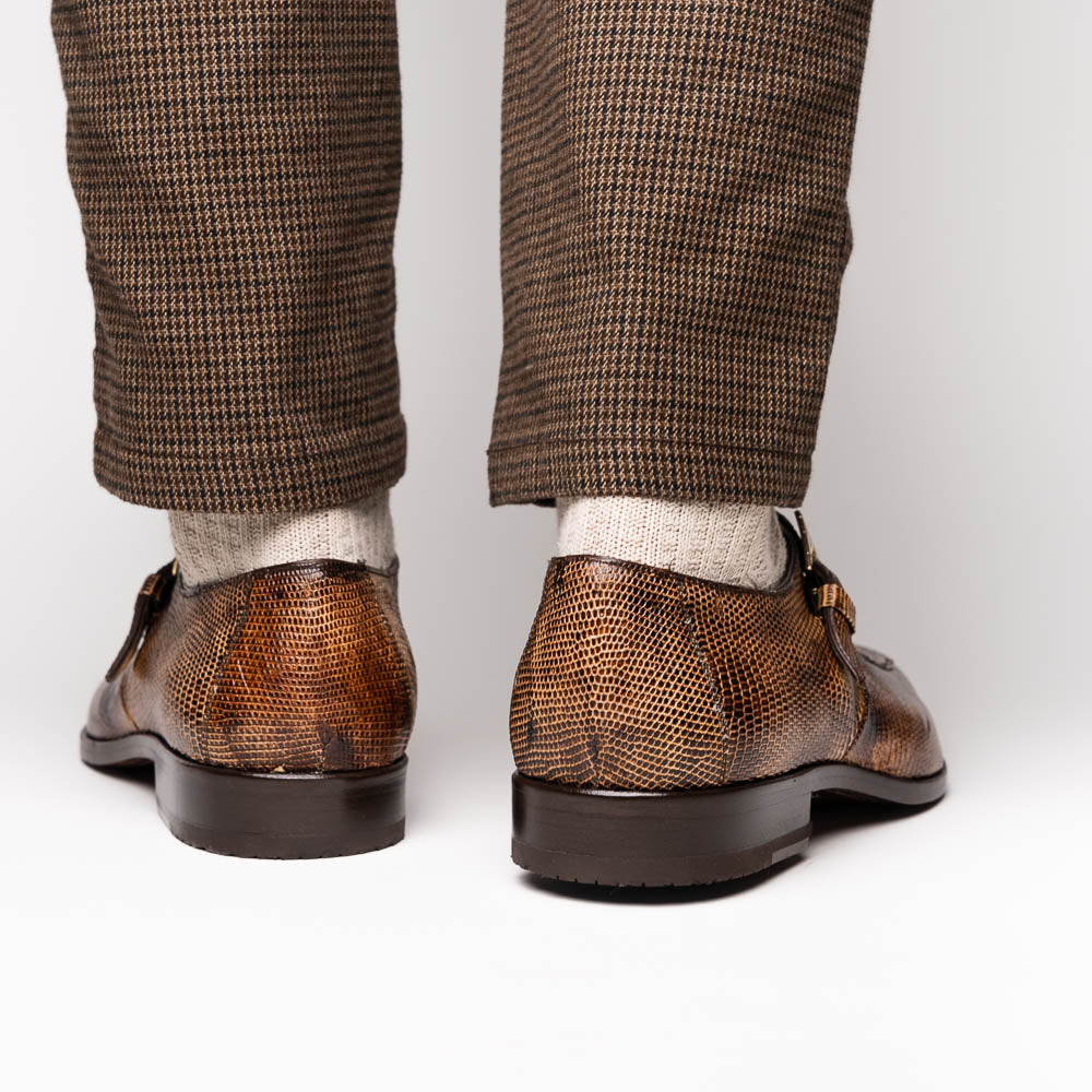A pair of Toluca Rustic Orix brown leather monk strap shoes by Marco Di Milano, featuring a crocodile pattern—one upright and one showing the branded sole—luxurious footwear perfect for any occasion.
