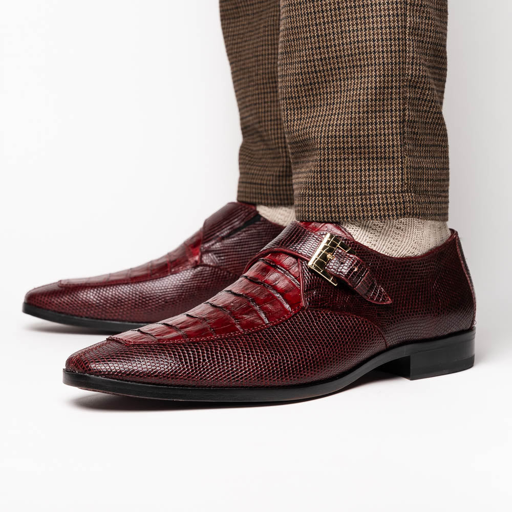 Toluca Wine by Marco Di Milano: Elegant burgundy monk strap shoes with genuine crocodile texture and black soles—one stands upright, the other lies on its side, showcasing luxury craftsmanship.