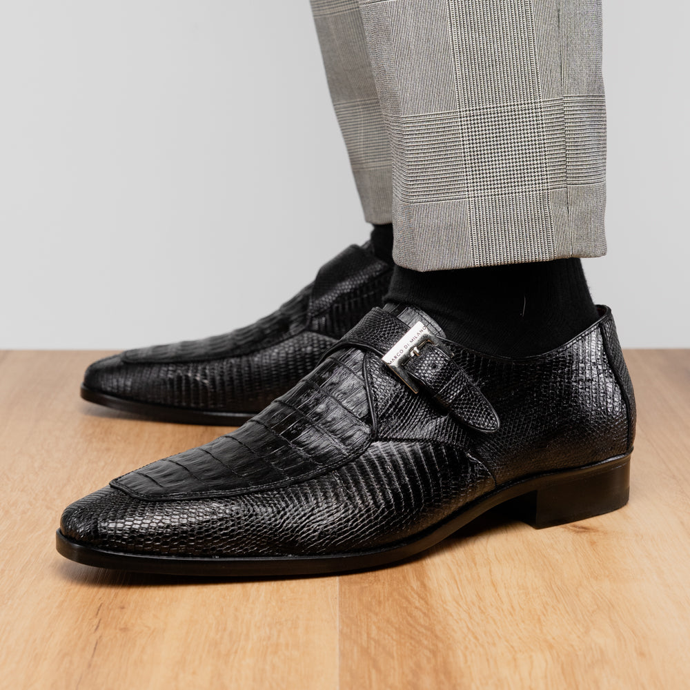 Toluca Black by Marco Di Milano: a black leather dress shoe featuring a crocodile texture and an elegant monk strap side buckle, displayed with one shoe upright and the other revealing its brown leather sole—a refined luxury footwear choice.