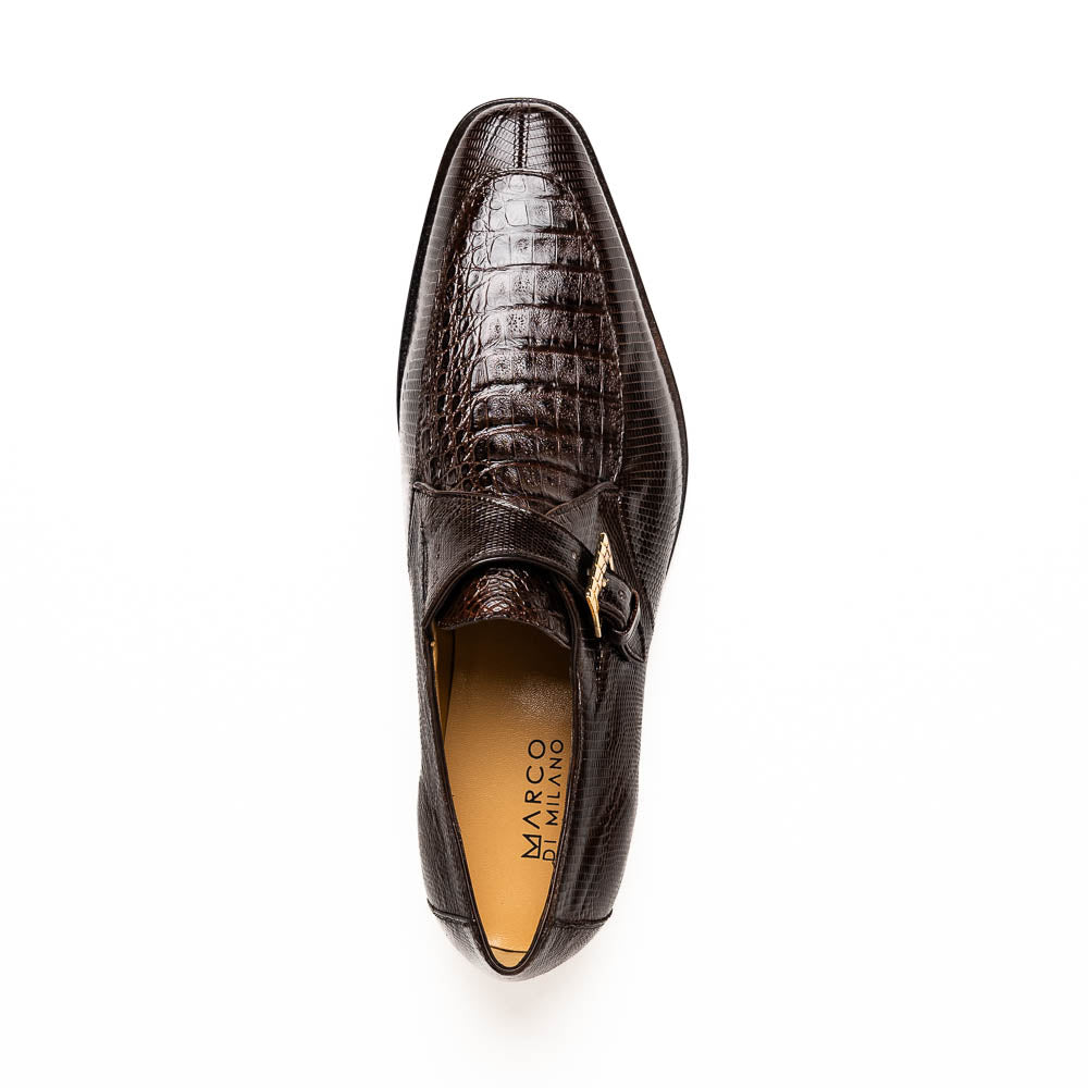 Toluca Brown by Marco Di Milano: luxury men's monk strap shoes in brown crocodile-patterned leather with a side buckle. One shoe stands upright; the other lies on its side to display the sole.
