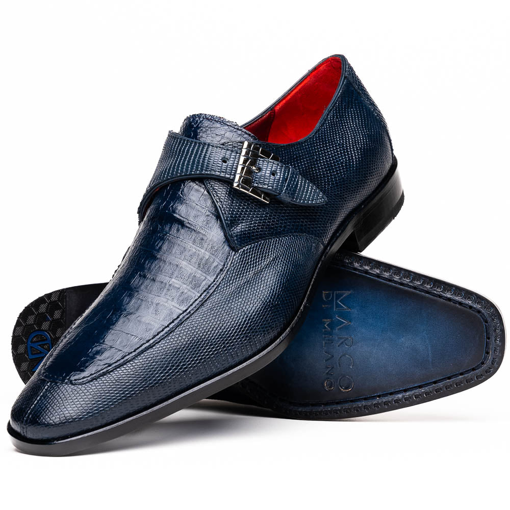 Toluca Navy by Marco Di Milano: a pair of blue textured leather monk strap shoes with a single buckle—one upright, one sole-up showing the brand name—a luxury footwear choice for refined tastes.