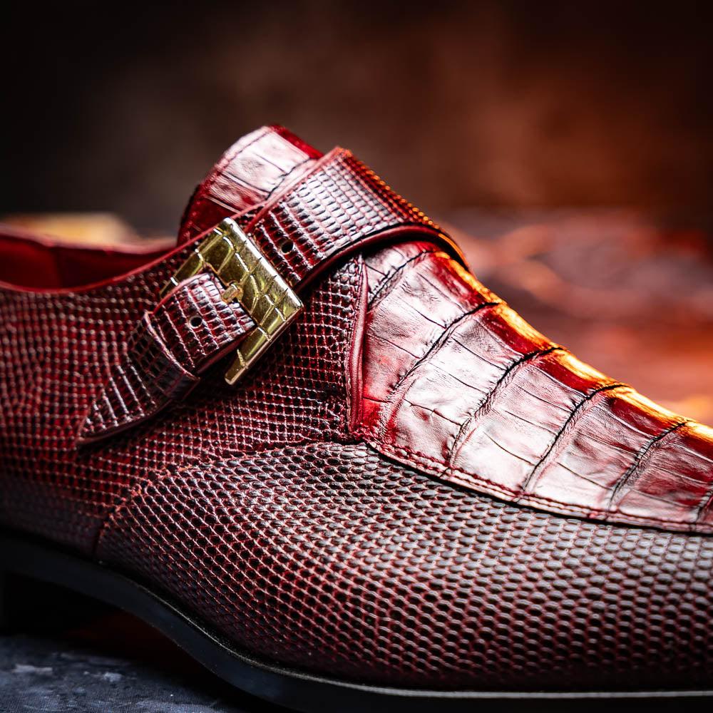 Toluca Wine by Marco Di Milano: Elegant burgundy monk strap shoes with genuine crocodile texture and black soles—one stands upright, the other lies on its side, showcasing luxury craftsmanship.