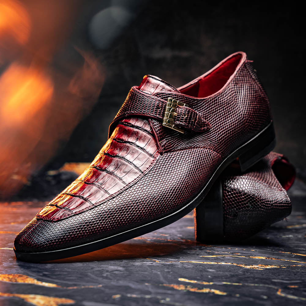 Toluca Wine by Marco Di Milano: Elegant burgundy monk strap shoes with genuine crocodile texture and black soles—one stands upright, the other lies on its side, showcasing luxury craftsmanship.
