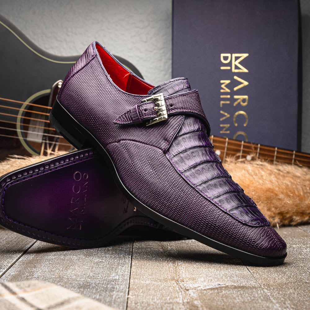 The Toluca Purple by Marco Di Milano is a pair of luxury monk strap shoes with textured purple leather, a silver buckle, red inner lining, and vibrant purple soles—one shoe rests against the other to showcase its unique sole design.