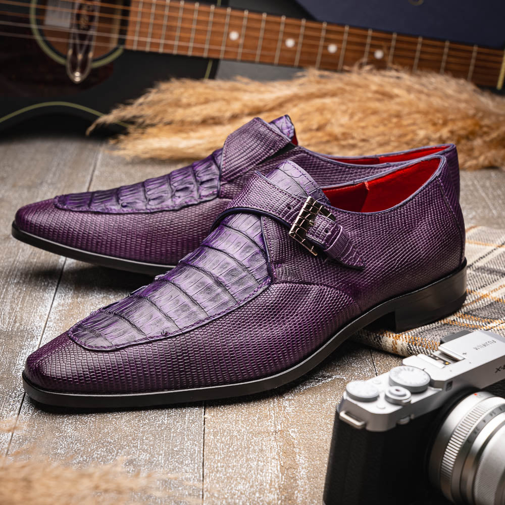 The Toluca Purple by Marco Di Milano is a pair of luxury monk strap shoes with textured purple leather, a silver buckle, red inner lining, and vibrant purple soles—one shoe rests against the other to showcase its unique sole design.